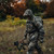 hunter walking in a field in the rain