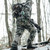 hunter wearing wind brace pro hiking up a hill