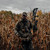hunter wearing forefront pro walking in a corn field