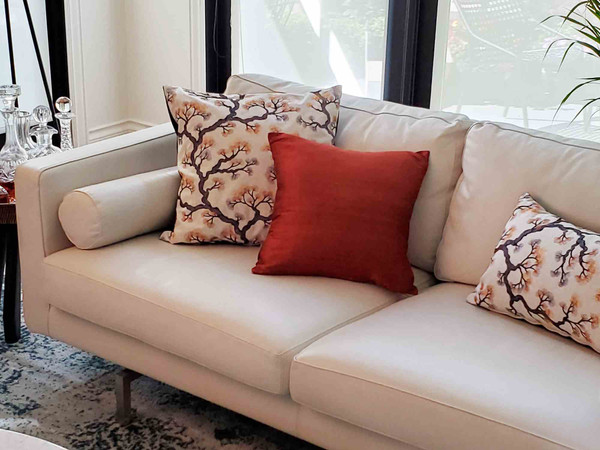 Sankara Burnt Orange Silk Throw Pillow on Sofa