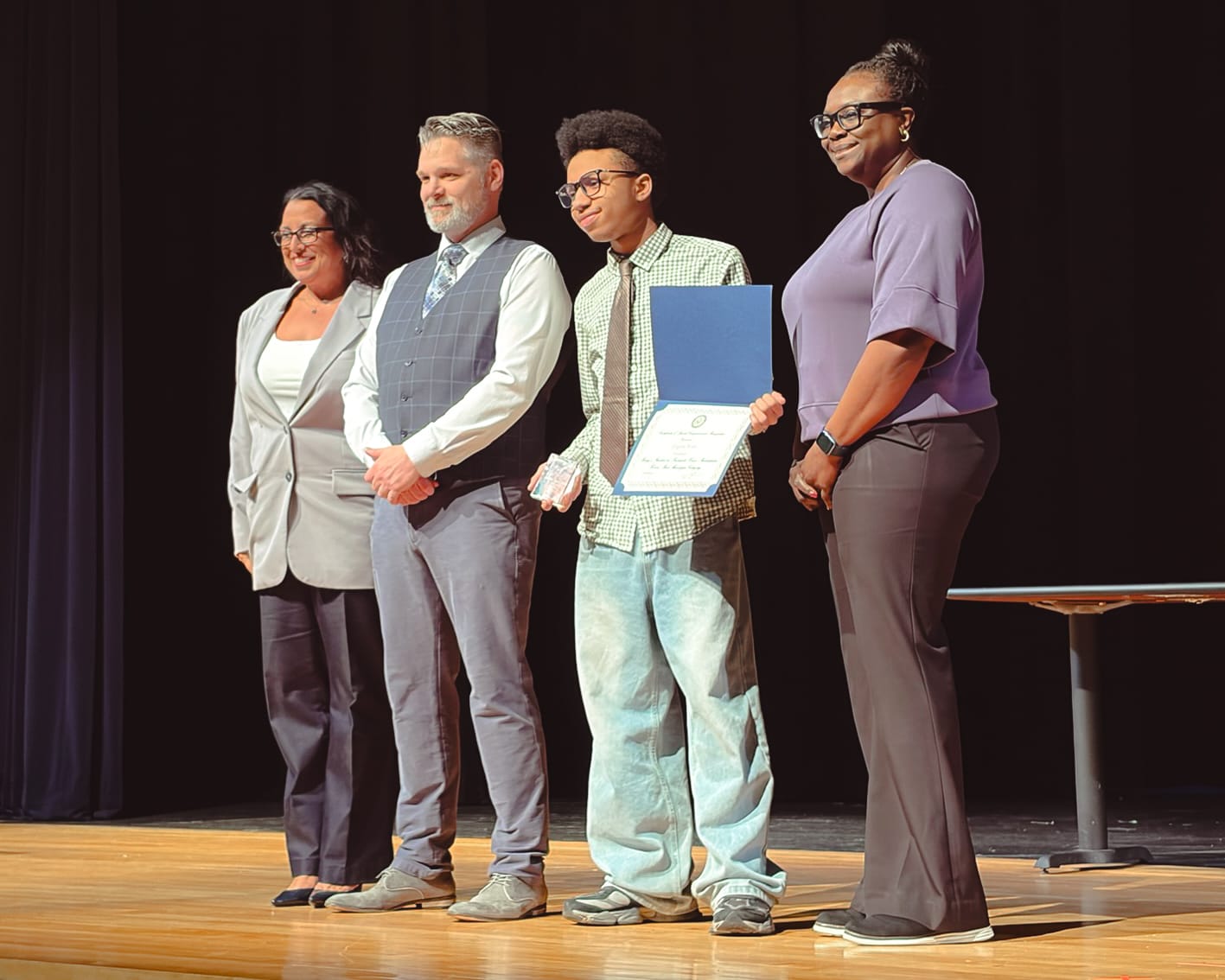 Eugene Watts receiving his 2025 monologue finalist certificate