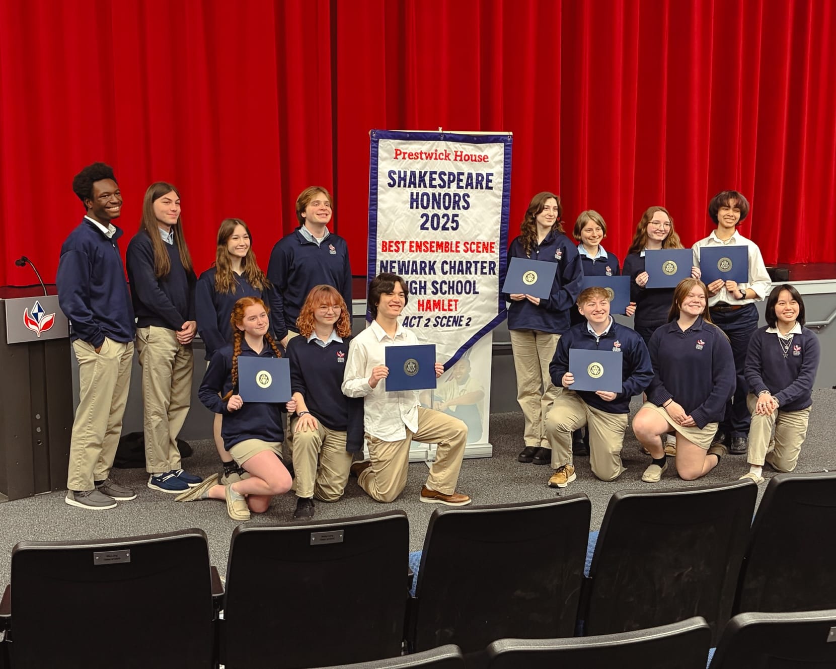 Newark Charter High School cast and crew with the 2025 Best Ensemble Scene banner