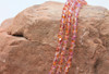 Fire Polish 4mm Faceted Round - Dual Coated - Fuchsia / Cantaloupe