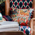 FASNACHT Cushion (LC40193) by Mind The Gap Designer Pillows | LC40193 | TYROL APRES-SKI HOME COLLECTION | 20 x 20 in | Blue, Green, Red, Taupe | Fabric Carolina | https://www.fabriccarolina.com/