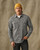 Model wearing a Filson Light Weight Alaskan Guide Shirt in Light Charcoal Plaid