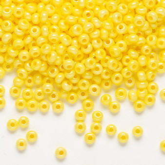 Seed bead, Preciosa Ornela, Czech glass, opaque luster terra dyed yellow, #8 rocaille. Sold per 500-gram pkg.