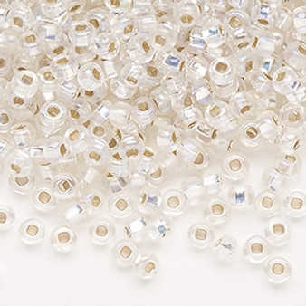 Seed bead, Preciosa Ornela, Czech glass, translucent silver-lined rainbow clear, #6 rocaille with square hole. Sold per 50-gram pkg.