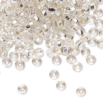 Seed bead, Preciosa Ornela, Czech glass, transparent silver-lined crystal clear, #6 rocaille with square hole. Sold per 50-gram pkg.