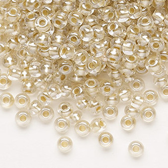 Seed bead, Preciosa Ornela, glass, translucent mocca pearl-lined crystal clear, #6 rocaille. Sold per 50-gram pkg.