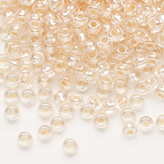 Seed bead, Preciosa Ornela, glass, translucent salmon pearl-lined crystal clear, #6 rocaille. Sold per 50-gram pkg.