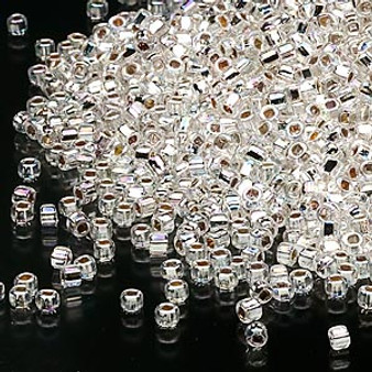 Seed bead, Dyna-Mites™, glass, silver-lined translucent rainbow clear, #11 round with square hole. Sold per 40-gram pkg.