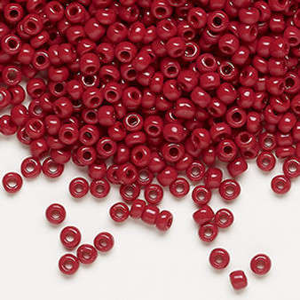 Seed bead, Dyna-Mites™, glass, opaque brick red, #8 round. Sold per 40-gram pkg.