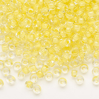 Seed bead, Dyna-Mites™, glass, translucent inside color light yellow, #6 round. Sold per 40-gram pkg.