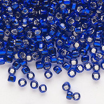 Seed bead, Dyna-Mites™, glass, silver-lined translucent cobalt, #6 round with square hole. Sold per 40-gram pkg.