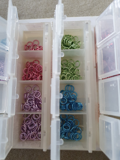 Sold as is - craftsmates container with various coloured aluminium jumprings