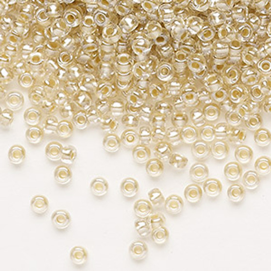 Seed bead, Preciosa Ornela, glass, translucent mocca pearl-lined crystal clear, #8 rocaille. Sold per 500-gram pkg.