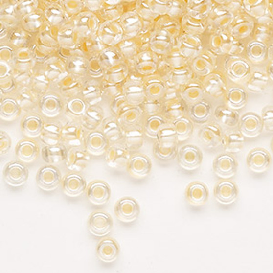 Seed bead, Preciosa Ornela, Czech glass, translucent color-lined pastel apricot luster (382PA), #6 rocaille. Sold per 50-gram pkg.