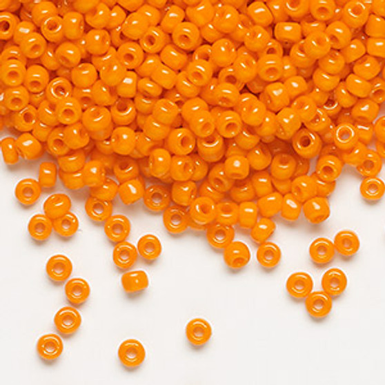 Seed bead, Dyna-Mites™, glass, opaque orange, #8 round. Sold per 40-gram pkg.