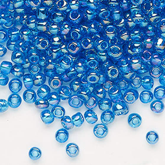 Seed bead, Dyna-Mites™, glass, transparent rainbow teal, #6 round. Sold per 40-gram pkg.