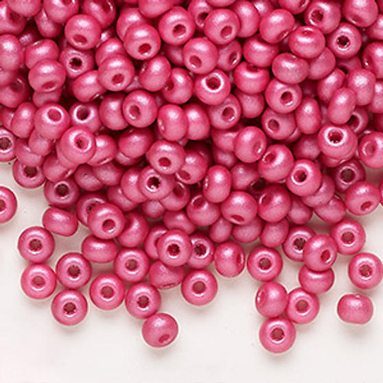 Seed bead, Preciosa Ornela, Czech glass, opaque chalkwhite PermaLux dyed magenta, #6 rocaille. Sold per 50-gram pkg.