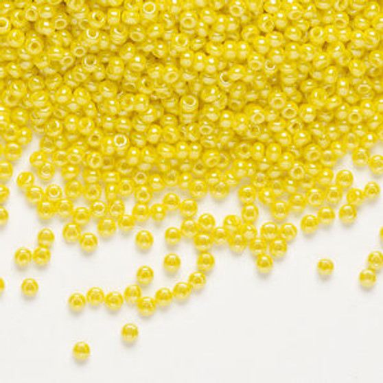 Seed bead, Preciosa Ornela, glass, opaque luster yellow, #11 rocaille. Sold per 50-gram pkg