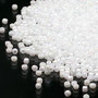 Seed bead, Dyna-Mites™, glass, opaque rainbow white, #11 round. Sold per 40-gram pkg.