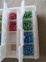 Sold as is - craftsmates container with various coloured aluminium jumprings