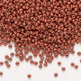 Seed bead, Preciosa Ornela, Czech glass, opaque chalkwhite PermaLux dyed brown, #11 rocaille. Sold per 50-gram pkg.