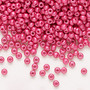 Seed bead, Preciosa Ornela, Czech glass, opaque chalkwhite PermaLux dyed magenta, #8 rocaille. Sold per 50-gram pkg.