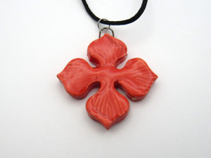 A solid red 4 pointed petal Flower shaped ceramic pendant necklace. On a black cord necklace. A solid red 4 pointed petal Flower shaped ceramic pendant necklace. On a black cord necklace.