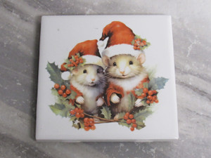 A handcrafted Christmas Mice Couple (Version A) ceramic Holiday trivet hot pad. A handcrafted Christmas Mice Couple (Version A) ceramic Holiday trivet hot pad.