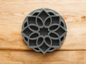 A mandala accent (design 4) clay pottery texture stamp. On a wood look background. A mandala accent (design 4) clay pottery texture stamp. On a wood look background.