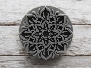 A mandala accent (Design 2) clay pottery texture stamp. On a wood look background. A mandala accent (Design 2) clay pottery texture stamp. On a wood look background.