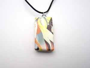 A handmade ceramic abstract (design 2) infusion rectangle pendant necklace. On a black cord necklace. A handmade ceramic abstract (design 2) infusion rectangle pendant necklace. On a black cord necklace.