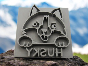 A husky dog Mug Clay Pottery Stamp for slab pottery. With a blue sky with white clouds look background.