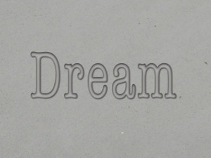 A clay imprint of the word Dream from an inspirational "Dream" clay pottery mug stamp for slab handbuild pottery. A clay imprint of the word Dream from an inspirational "Dream" clay pottery mug stamp for slab handbuild pottery.
