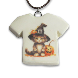 A handmade ceramic Halloween Tshirt Black cat with witches hat pendant. On a black cord necklace. A handmade ceramic Halloween Tshirt Black cat with witches hat pendant. On a black cord necklace.