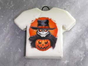 A handmade ceramic Halloween Tshirt Necklace with Skeleton with a top hat Dressed in Black with a Pumpkin. A handmade ceramic Halloween Tshirt Necklace with Skeleton with a top hat Dressed in Black with a Pumpkin.