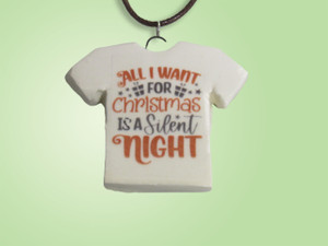 A handmade fun Christmas Tshirt shaped necklace with the words "All I Want For Christmas is a Silent Night". With a green background. A handmade fun Christmas Tshirt shaped necklace with the words "All I Want For Christmas is a Silent Night". With a green background.