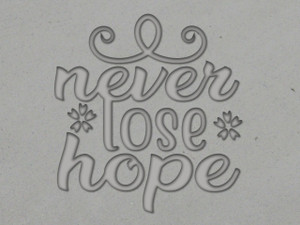 A clay imprint of an Inspirational "Never Lose Hope" clay stamp for slab built pottery. A clay imprint of an Inspirational "Never Lose Hope" clay stamp for slab built pottery.