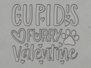 A clay imprint of A mug clay stamp with the words Cupid's Furry Valentine for handbuild Pottery. A clay imprint of A mug clay stamp with the words Cupid's Furry Valentine for handbuild Pottery.