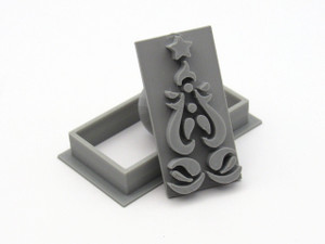 An abstract tree clay pottery stamp and cutter. Shown with stamp tilted against cutter. An abstract tree clay pottery stamp and cutter. Shown with stamp tilted against cutter.