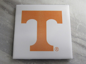 A UT Vols Orange Power T Ceramic Coaster Hot Pad Trivet. With a gray marble look background. A UT Vols Orange Power T Ceramic Coaster Hot Pad Trivet. With a gray marble look background.