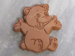 A finished handmade cute bear terracotta brown sugar saver. On a gray marble look background. A finished handmade cute bear terracotta brown sugar saver. On a gray marble look background.
