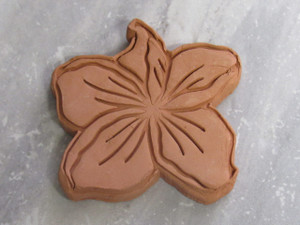 A finished Tropical Hibiscus terracotta brown clay sugar saver. With a gray marble look background. A finished Tropical Hibiscus terracotta brown clay sugar saver. With a gray marble look background.