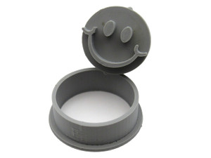 A Happy Face Round Clay Pendant Stamp with pottery cutter. Shown with stamp tilted on top of cutter.