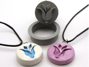 An abstract tulip clay pendant stamp and cutter. Shown with two finished necklaces; one white with a teal flower and the other solid purple. An abstract tulip clay pendant stamp and cutter. Shown with two finished necklaces, one white with teal flower and the other solid purple. An abstract tulip clay pendant stamp and cutter. Shown with two finished necklaces; one white with a teal flower and the other solid purple. An abstract tulip clay pendant stamp and cutter. Shown with two finished necklaces, one white with teal flower and the other solid purple.