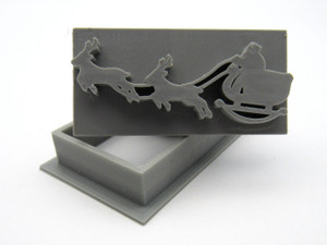 A santa's sleigh and reindeer, rectangle, pendant clay stamp with cutter. A santa's sleigh and reindeer, rectangle, pendant clay stamp with cutter.