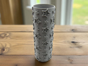 A Star Texture Roller Stamp for Ceramic Clay Pottery. The stamp has large outlined stars and small solid stars covering the texture roller. Shown on a table look background. A Star Texture Roller Stamp for Ceramic Clay Pottery. The stamp has large outlined stars and small solid stars covering the texture roller. Shown on a table look background.