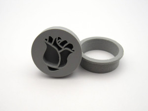 An inverted rosebud flower pendant clay stamp with round cutter. Shown with stamp tilted next to the cutter. An inverted rosebud flower pendant clay stamp with round cutter. Shown with stamp tilted next to the cutter.
